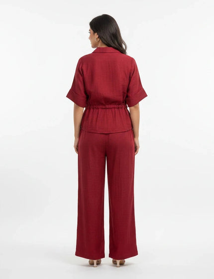 Back view of a woman wearing a Sagar hill road maroon utility co-ord set with a belted shirt and wide-leg trousers.