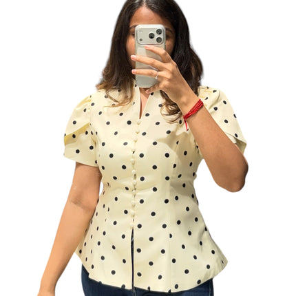 Sagar hill road butter yellow polka dot peplum top with button-front, short sleeves, and a flattering fit and flare silhouette.