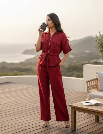 Sagar hill road deep red utility co-ord set with zip-front shirt and wide-leg trousers worn on a scenic terrace